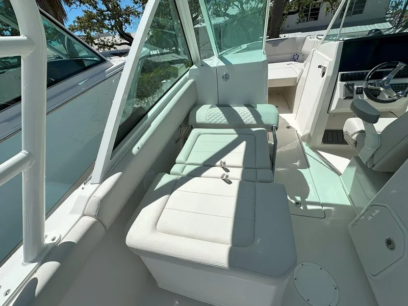 Slide: The Image of 2025 Sailfish 276 DC boat interior with seating and steering wheel, showcasing modern design. - 28