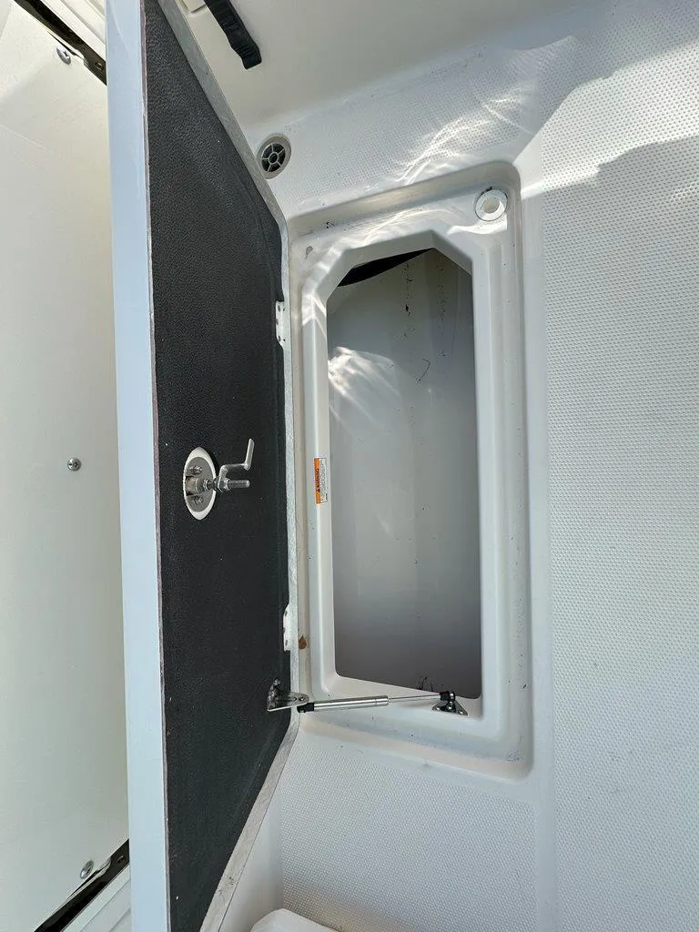 Slide: The Image of Open storage compartment on a 2025 Sailfish 276 DC boat. - 32