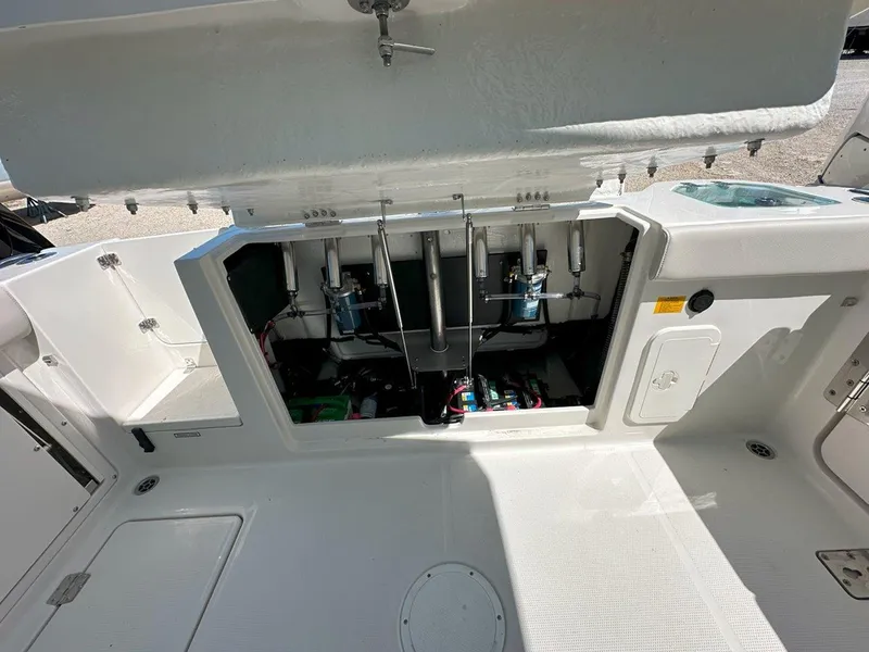 Slide: The Image of 2025 Sailfish 276 DC boat interior showing open storage compartment and mechanical components. - 35