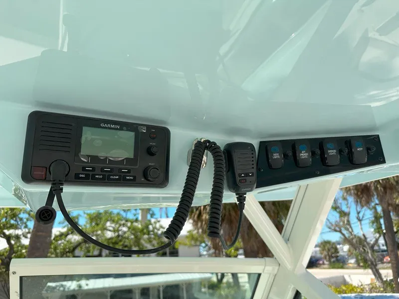Slide: The Image of 2025 Sailfish 276 DC boat dashboard with Garmin radio and control switches. - 36