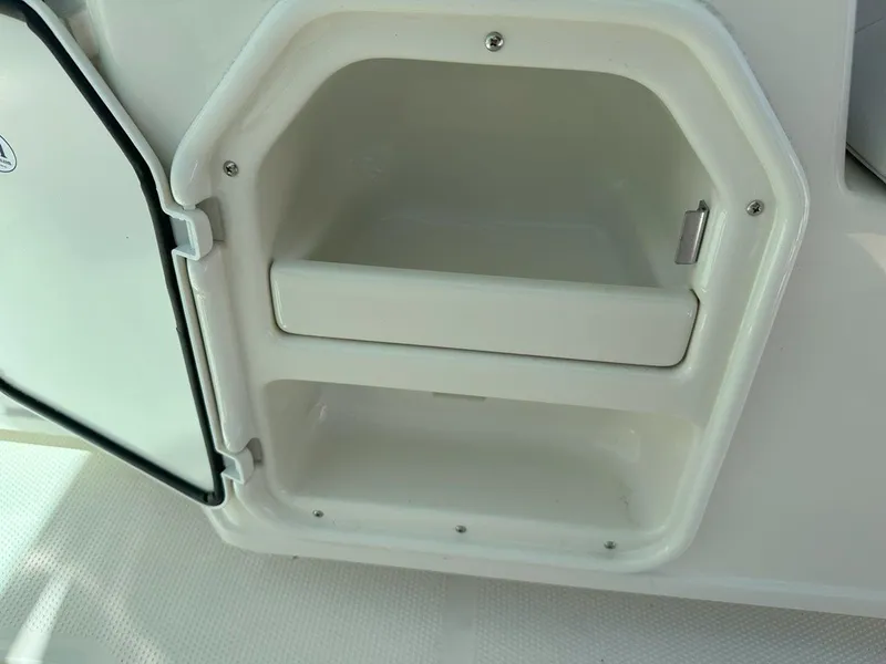 Slide: The Image of Open storage compartment on 2025 Sailfish 276 DC boat. - 38