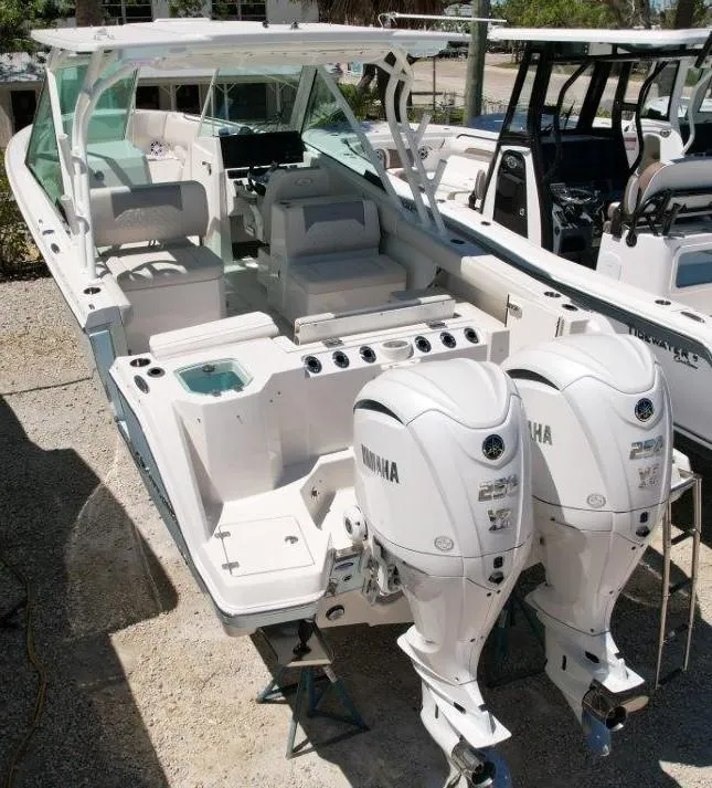 Slide: The Image of 2025 Sailfish 276 DC boat with dual Yamaha engines, docked and ready for adventure. - 4