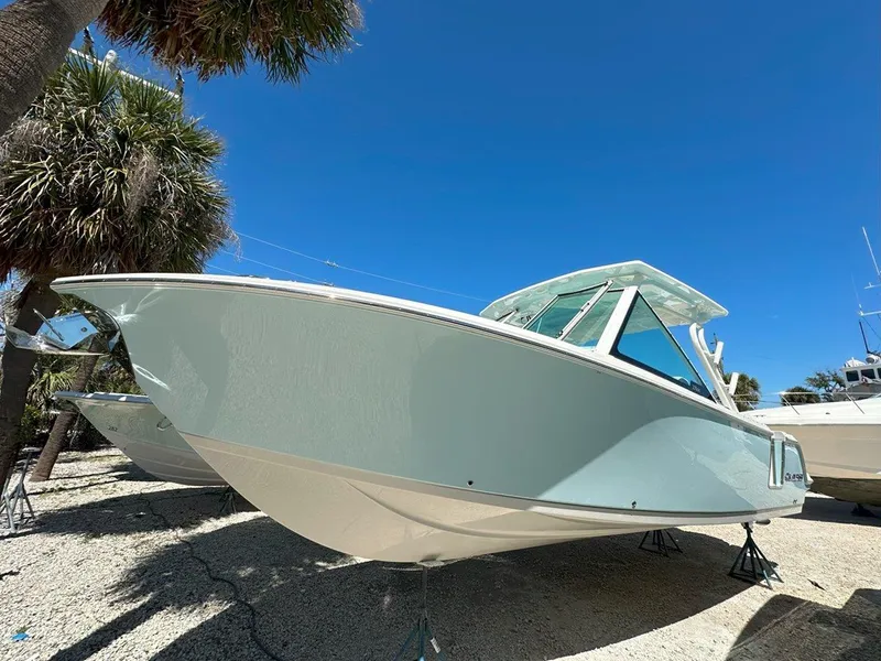 Slide: The Image of 2025 Sailfish 276 DC boat displayed outdoors under clear blue sky. - 5