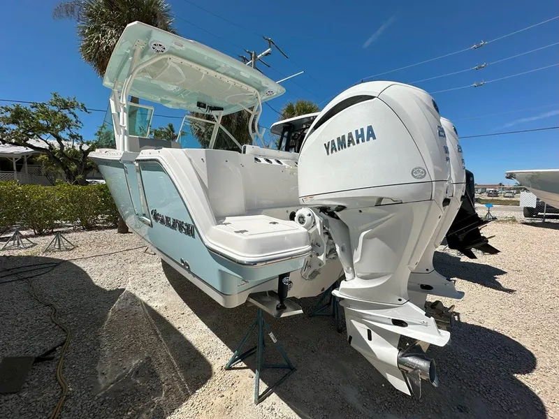 Slide: The Image of 2025 Sailfish 276 DC boat with Yamaha engines, displayed outdoors on a sunny day. - 8