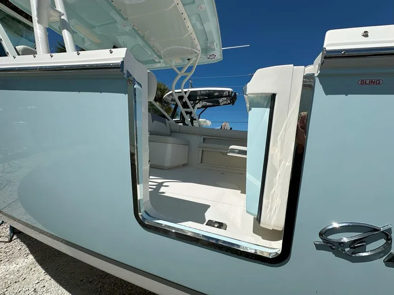 Slide: The Image of 2025 Sailfish 276 DC boat with open side door, showcasing interior seating and sleek design. - 9