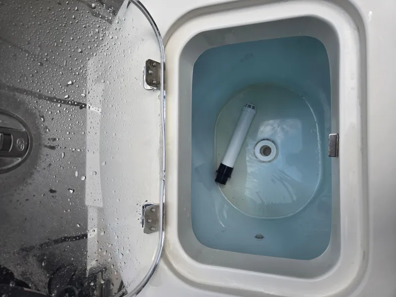 Slide: The Image of Livewell compartment on a 2015 Cobia 201 Center Console boat, with water and a filter. - 7