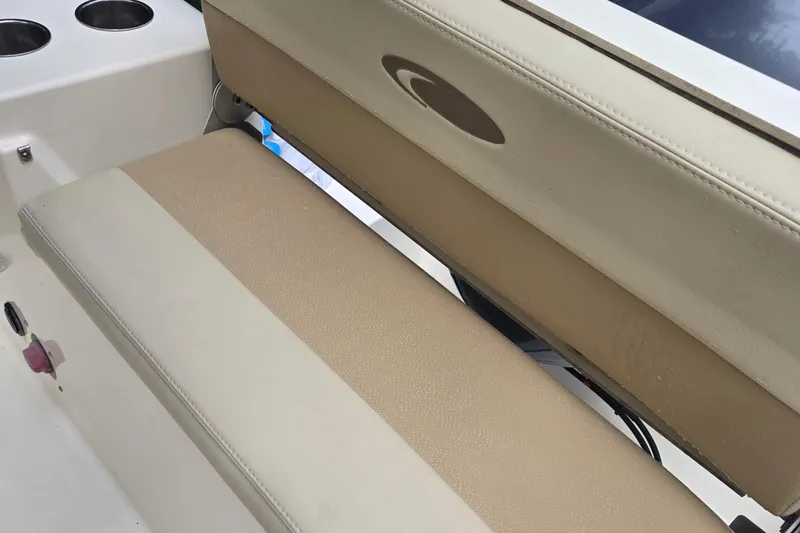 Slide: The Image of 2015 Cobia 201 Center Console boat seat with cup holders. - 8
