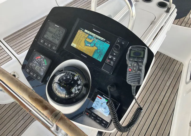 Slide: The Image of Cockpit navigation instruments on a 2002 Jeanneau 43DS sailboat, featuring compass and GPS display. - 5