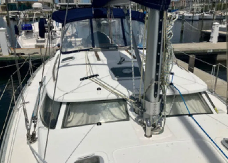 Slide: The Image of 2002 Jeanneau 43DS sailboat docked at a marina, featuring a sleek deck design. - 7