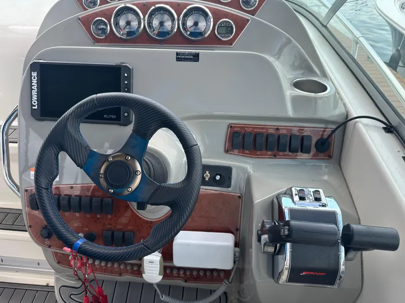 Slide: The Image of Control panel of a 2008 Bayliner 300SB boat with steering wheel and gauges. - 11