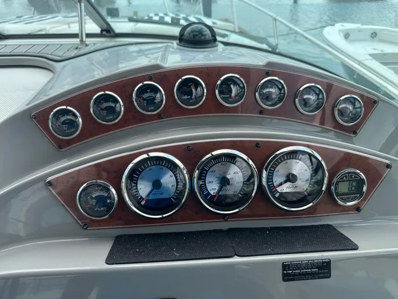 Slide: The Image of Dashboard of a 2008 Bayliner 300SB boat with various gauges and controls. - 12