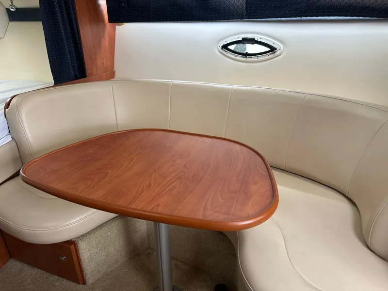 Slide: The Image of 2008 Bayliner 300SB interior with beige seating and wooden table. - 15