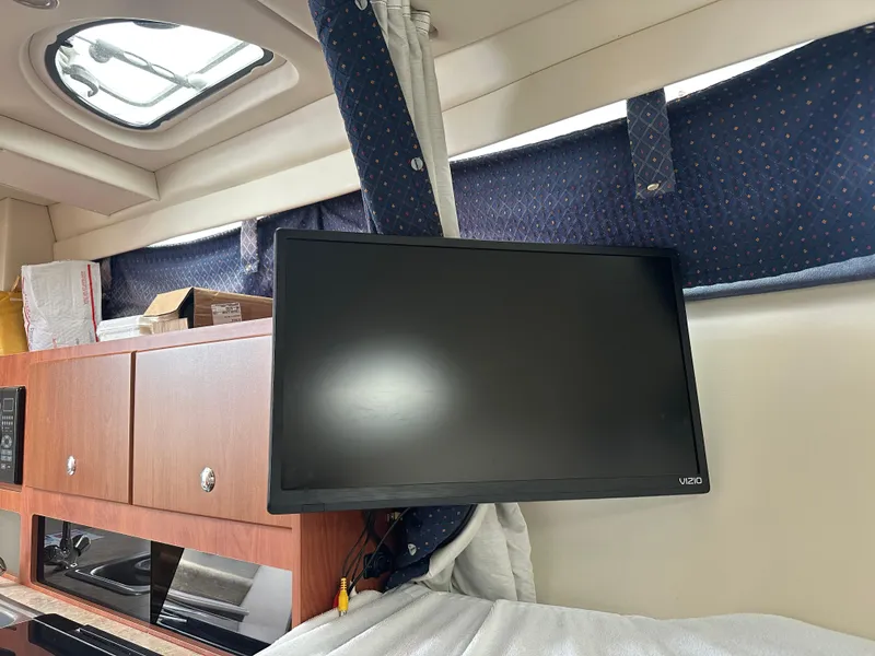 Slide: The Image of Interior of a 2008 Bayliner 300SB boat with a mounted Vizio TV. - 18