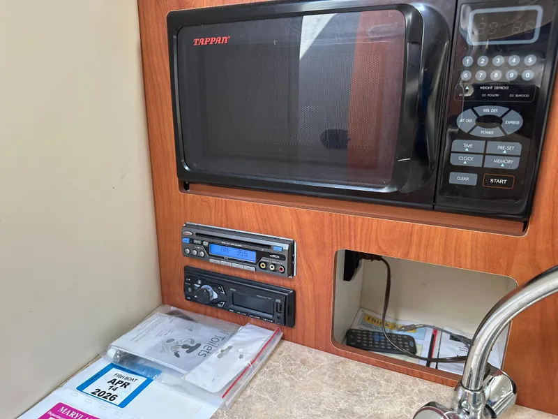 Slide: The Image of 2008 Bayliner 300SB interior with Tappan microwave, stereo system, and countertop. - 21
