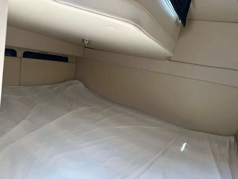Slide: The Image of Interior cabin of 2008 Bayliner 300SB boat with beige upholstery. - 23