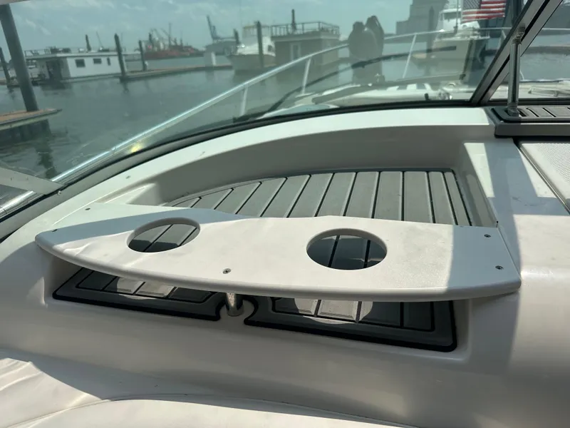 Slide: The Image of 2008 Bayliner 300SB boat deck with cup holders, docked at marina. - 25
