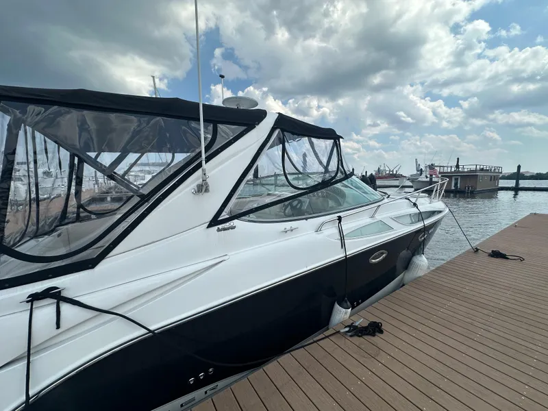 Slide: The Image of 2008 Bayliner 300SB boat docked at marina under cloudy sky. - 3