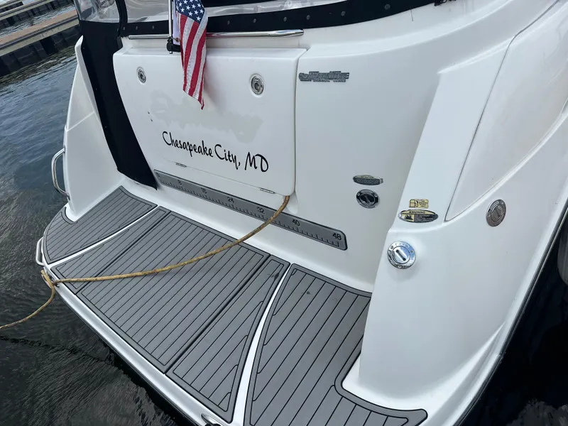 Slide: The Image of 2008 Bayliner 300SB boat stern with American flag, docked in Chesapeake City, MD. - 5