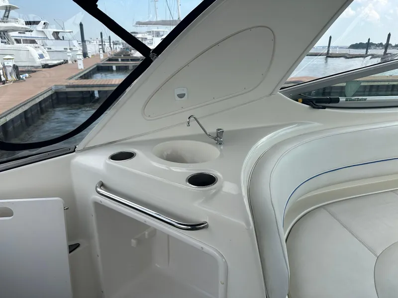 Slide: The Image of 2008 Bayliner 300SB boat interior with sink and seating at marina. - 8