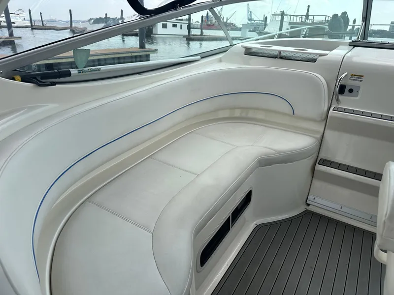 Slide: The Image of 2008 Bayliner 300SB boat interior with white seating and waterfront view. - 9
