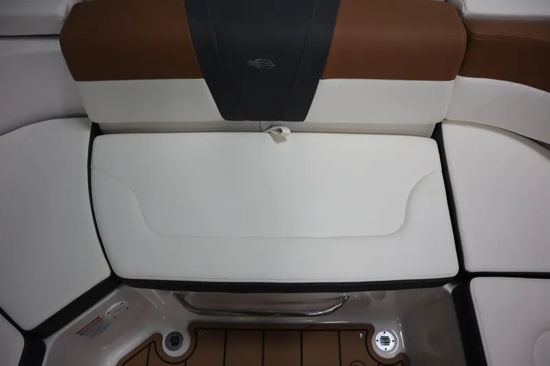 Slide: The Image of 2024 Chaparral 23 SSi boat interior seating, featuring white and brown cushioned design. - 17