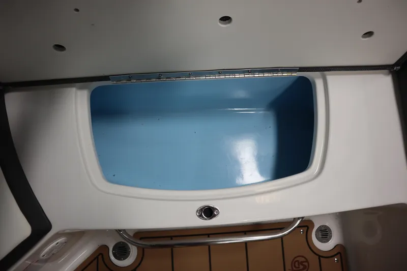Slide: The Image of 2024 Chaparral 23 SSi boat storage compartment with blue interior and white exterior. - 18