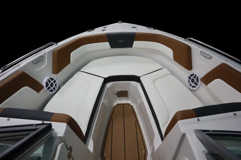 Slide: The Image of 2024 Chaparral 23 SSi boat interior with brown and white seating, speakers, and sleek design. - 2