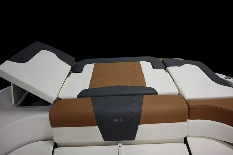 Slide: The Image of 2024 Chaparral 23 SSi boat interior with brown and white cushioned seating. - 21