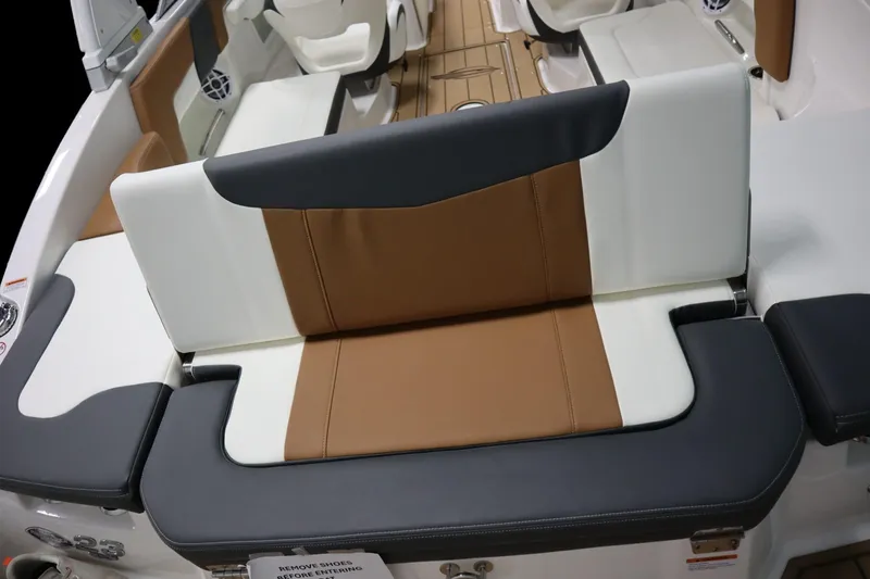 Slide: The Image of 2024 Chaparral 23 SSi boat interior with brown and white seating. - 22