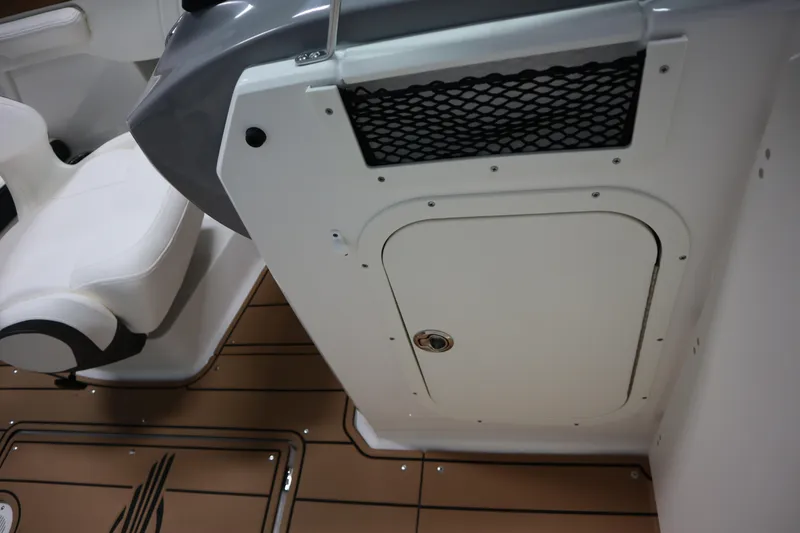 Slide: The Image of 2024 Chaparral 23 SSi boat interior with white seating and storage compartment. - 8