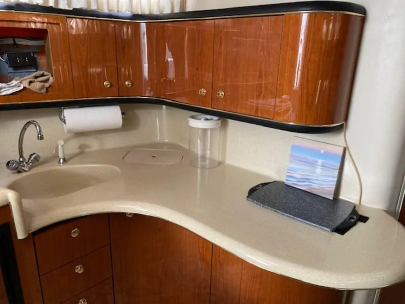 Slide: The Image of 1998 Sea Ray Sundancer 370 kitchen with wood cabinets and countertop. - 15