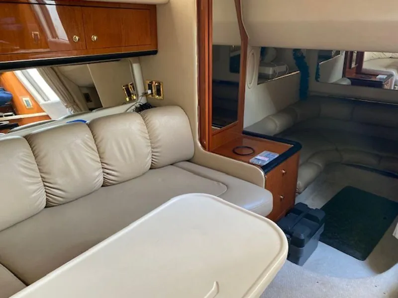 Slide: The Image of Interior of 1998 Sea Ray Sundancer 370 with beige seating and wooden cabinetry. - 17