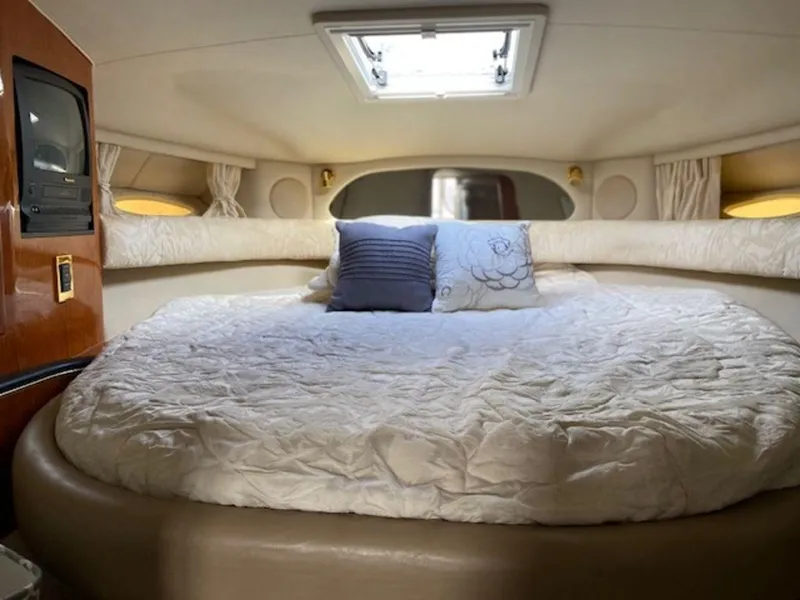 Slide: The Image of Cozy cabin interior of 1998 Sea Ray Sundancer 370 with plush bedding and natural light. - 19