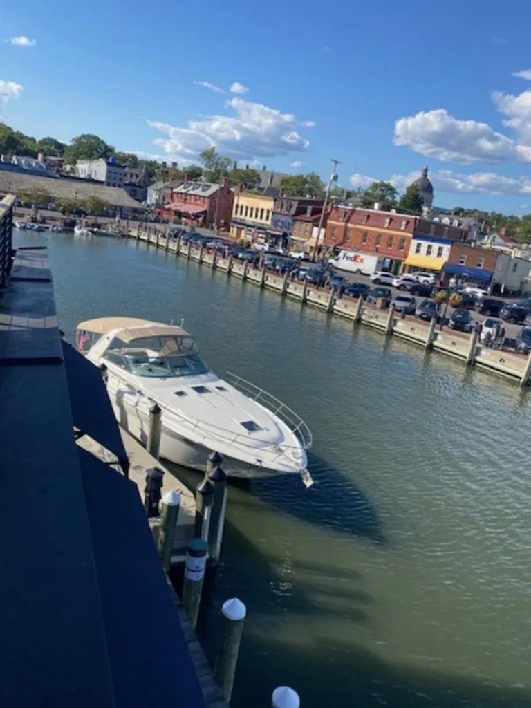 Slide: The Image of 1998 Sea Ray Sundancer 370 docked in a scenic harbor with blue sky. - 2