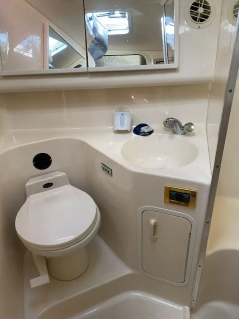 Slide: The Image of 1998 Sea Ray Sundancer 370 bathroom with toilet, sink, and mirror. - 20