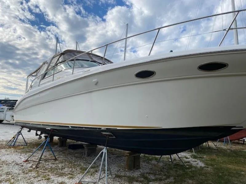 Slide: The Image of 1998 Sea Ray Sundancer 370 yacht on stands under a cloudy sky. - 4