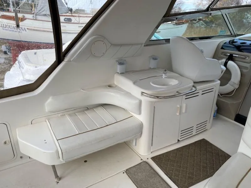 Slide: The Image of Interior of 1998 Sea Ray Sundancer 370, featuring seating and a compact sink area. - 8