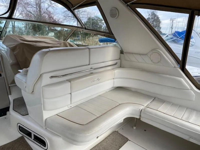 Slide: The Image of 1998 Sea Ray Sundancer 370 interior with white leather seating and covered dashboard. - 9