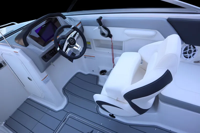 Slide: The Image of 2024 Chaparral 23 SSi OB boat interior with steering wheel and white seating. - 10