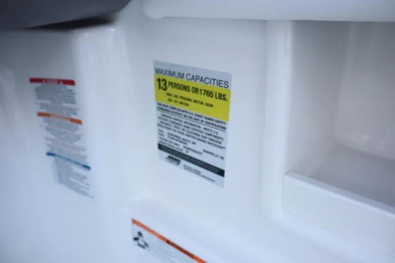 Slide: The Image of 2024 Chaparral 23 SSi OB capacity label, maximum 13 persons or 1765 lbs. - 16