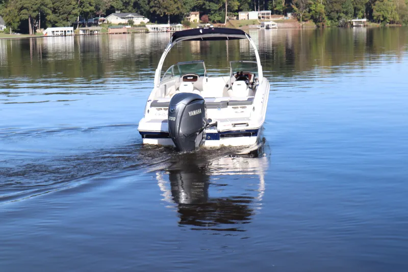 Slide: The Image of 2024 Chaparral 23 SSi OB boat cruising on a calm lake. - 3