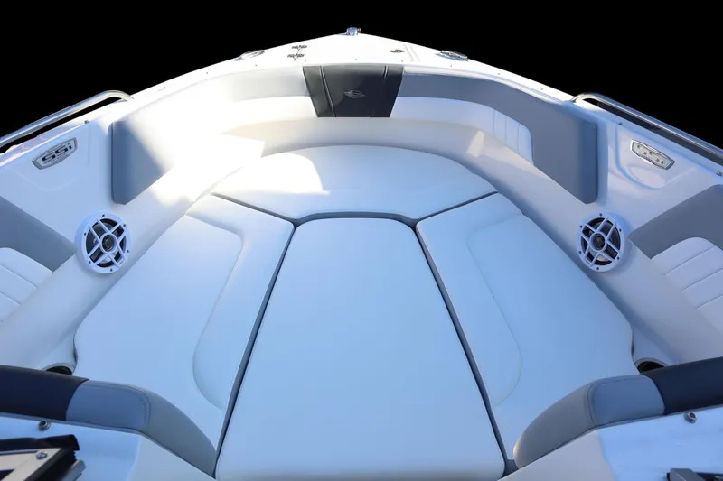 Slide: The Image of 2024 Chaparral 23 SSi OB boat interior with cushioned seating and speakers. - 8