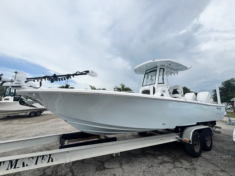 The Image of 2026 Tidewater 2700 Carolina Bay boat on trailer under cloudy sky. - 0