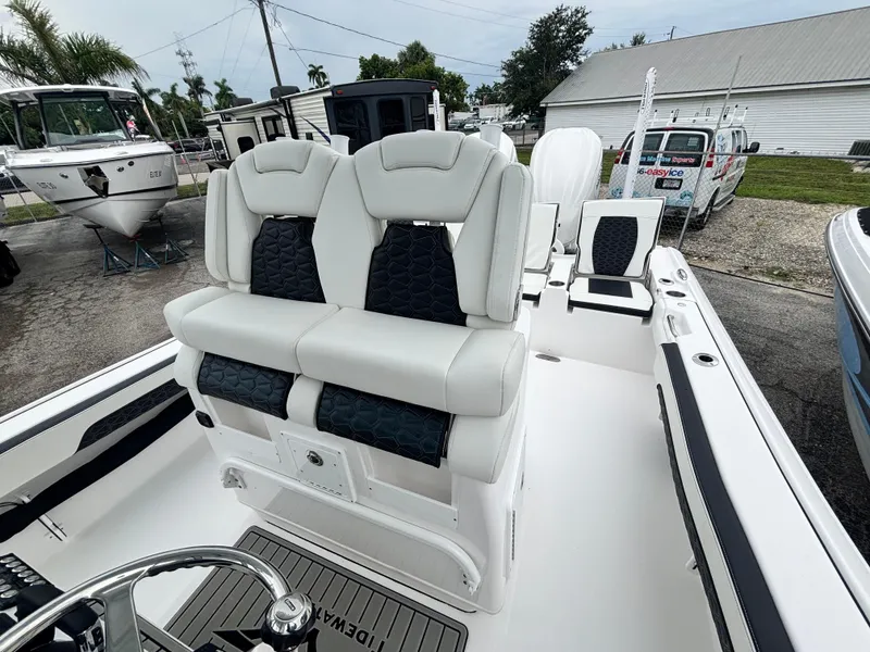 Slide: The Image of 2026 Tidewater 2700 Carolina Bay boat with dual cushioned seats and sleek design. - 13