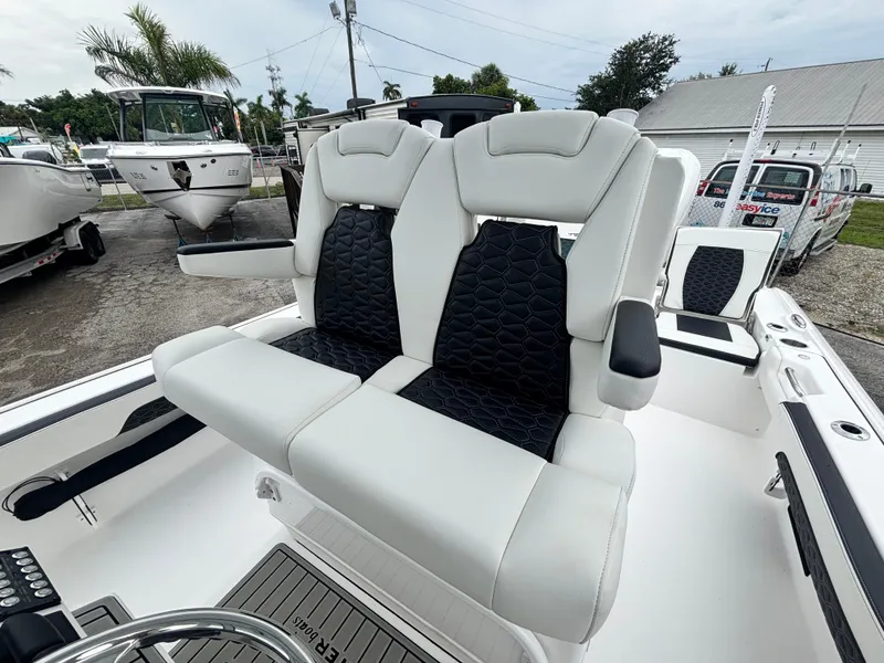 Slide: The Image of 2026 Tidewater 2700 Carolina Bay boat with dual cushioned seats and sleek design. - 14