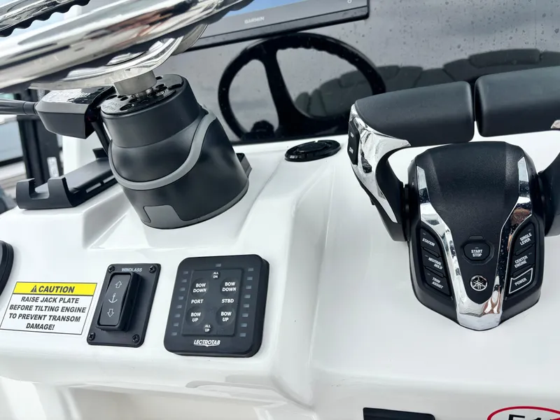 Slide: The Image of 2026 Tidewater 2700 Carolina Bay boat controls with steering wheel and throttle system. - 17