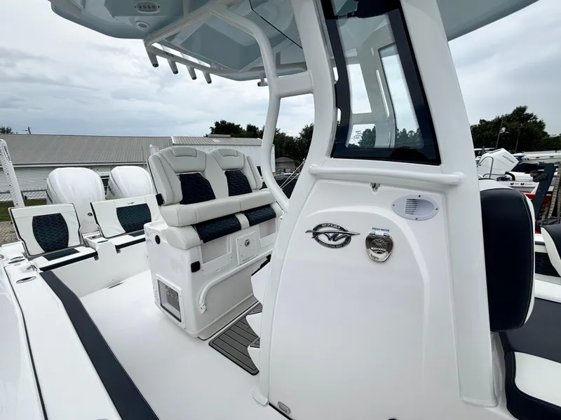 Slide: The Image of 2026 Tidewater 2700 Carolina Bay boat interior with seating and console details. - 19