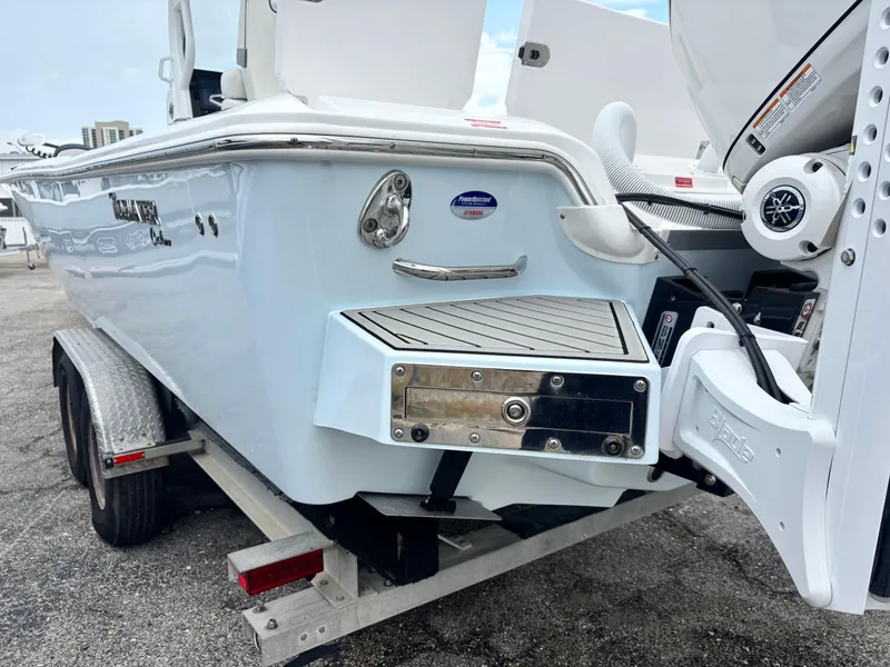 Slide: The Image of 2026 Tidewater 2700 Carolina Bay boat on trailer, rear view with motor and deck details. - 27