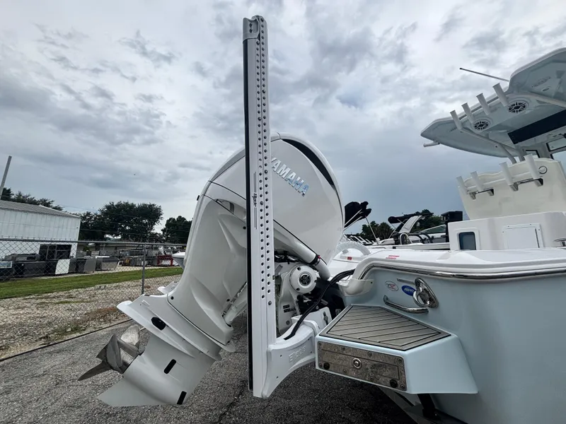 Slide: The Image of 2026 Tidewater 2700 Carolina Bay boat with Yamaha outboard motor, docked under cloudy skies. - 5
