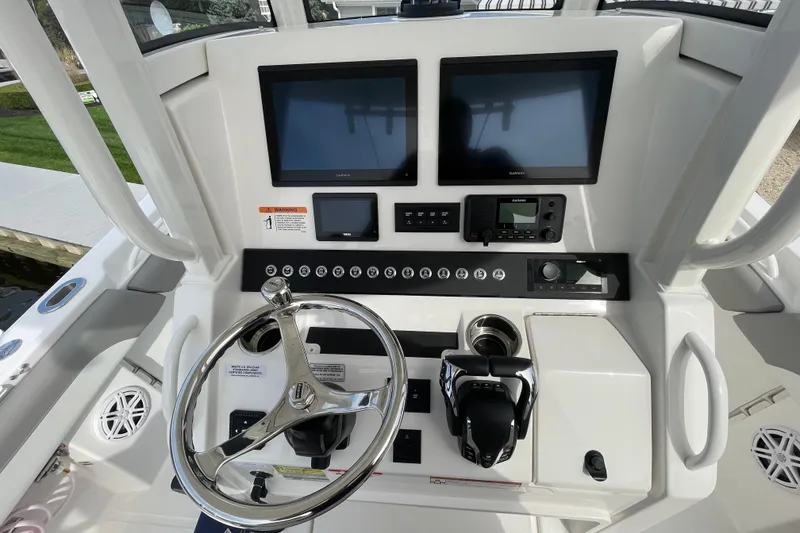 Slide: The Image of Helm of 2026 Regulator 25 boat with dual screens and controls. - 10